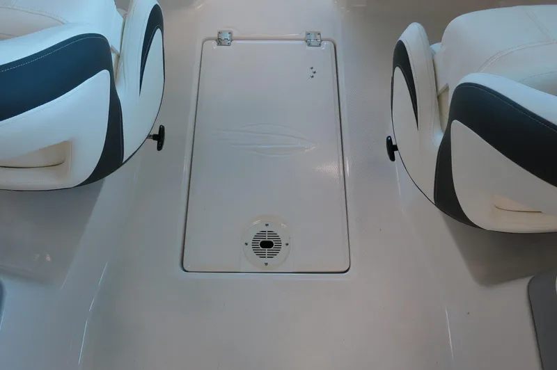 Slide: The Image of 2024 Chaparral 23 SSi OB boat interior with seating and storage compartment. - 21