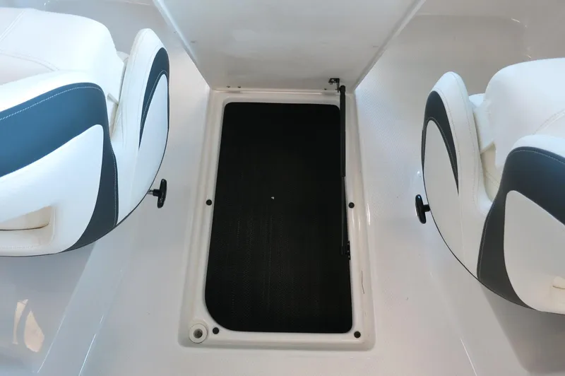Slide: The Image of 2024 Chaparral 23 SSi OB boat interior with storage compartment and seating. - 22