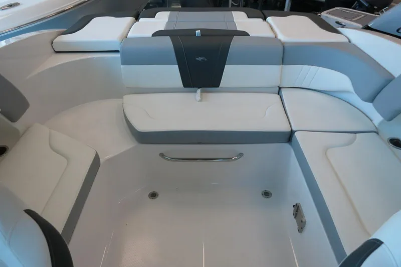 Slide: The Image of 2024 Chaparral 23 SSi OB boat interior with white and gray seating. - 24