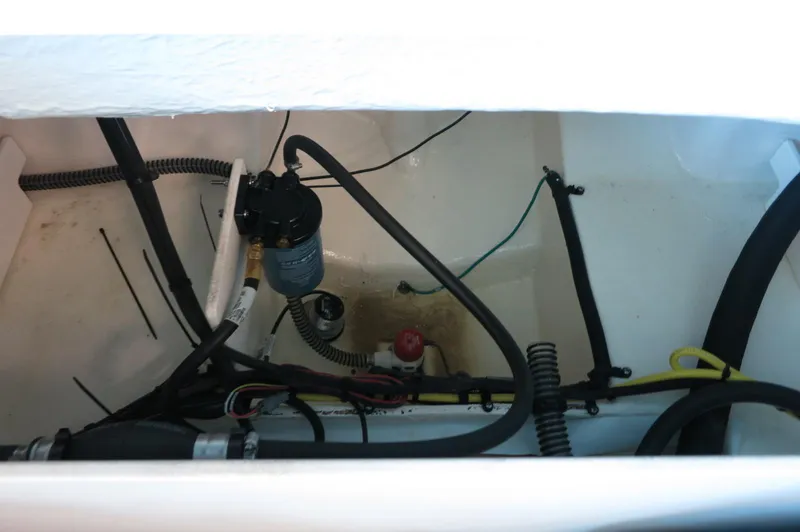 Slide: The Image of 2024 Chaparral 23 SSi OB boat engine compartment with wiring and components. - 31