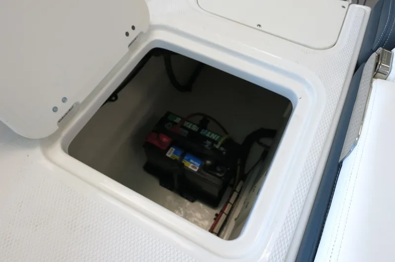 Slide: The Image of 2024 Chaparral 23 SSi OB boat battery compartment with secure storage. - 34