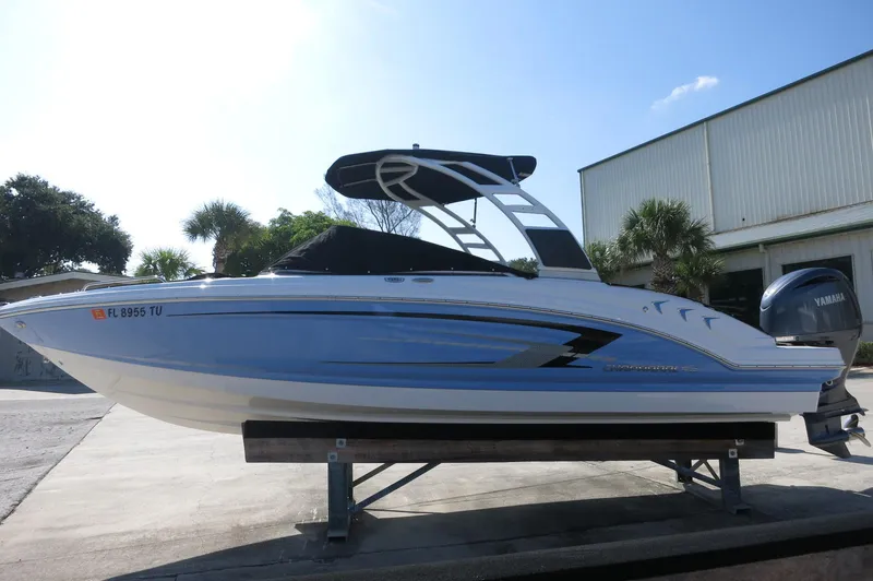 Slide: The Image of 2024 Chaparral 23 SSi OB boat on display, featuring sleek design and Yamaha outboard motor. - 39