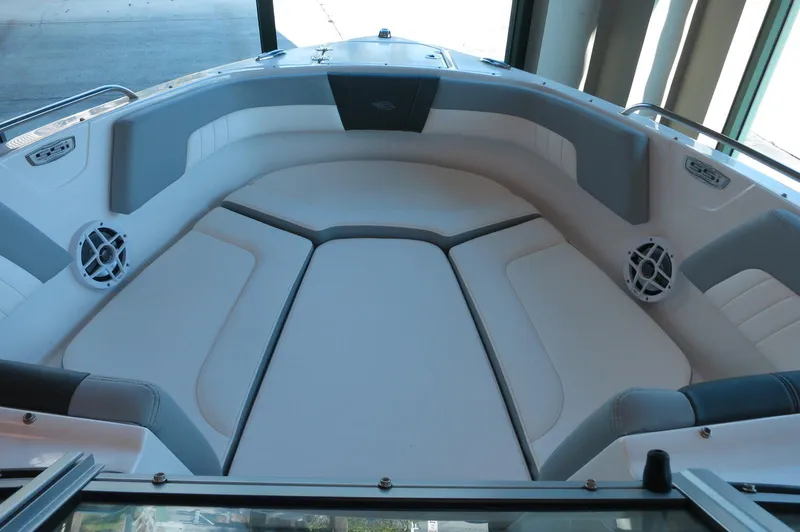 Slide: The Image of 2024 Chaparral 23 SSi OB boat interior with cushioned seating and speakers. - 8