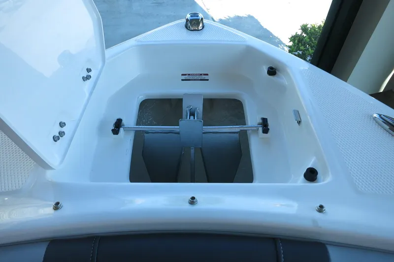 Slide: The Image of 2024 Chaparral 23 SSi OB boat anchor storage compartment, open lid view. - 9
