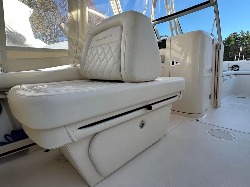 Slide: The Image of 2021 Grady-White Freedom 235 boat interior with white cushioned seating. - 10