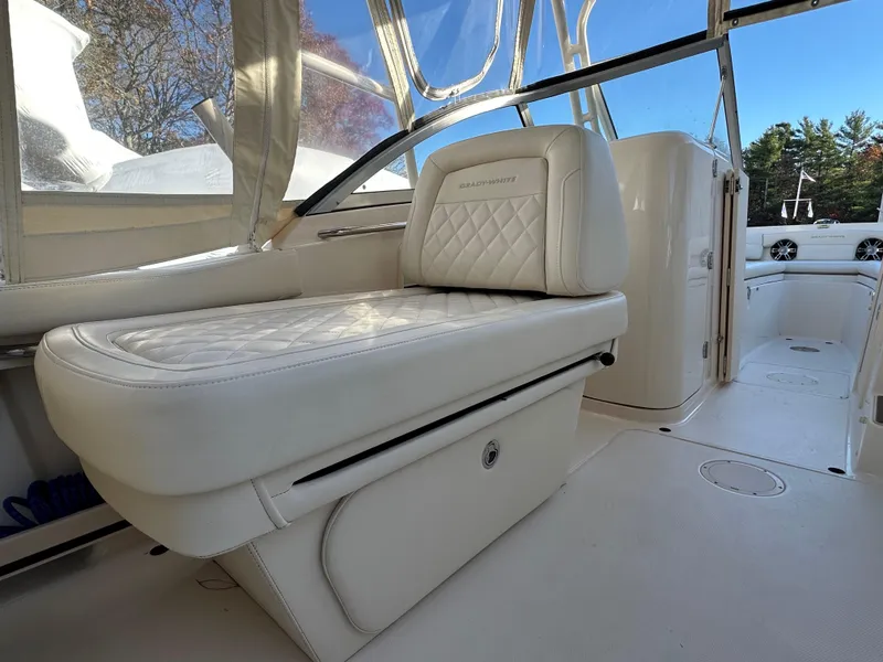 Slide: The Image of 2021 Grady-White Freedom 235 boat interior with white seating and sleek design. - 11