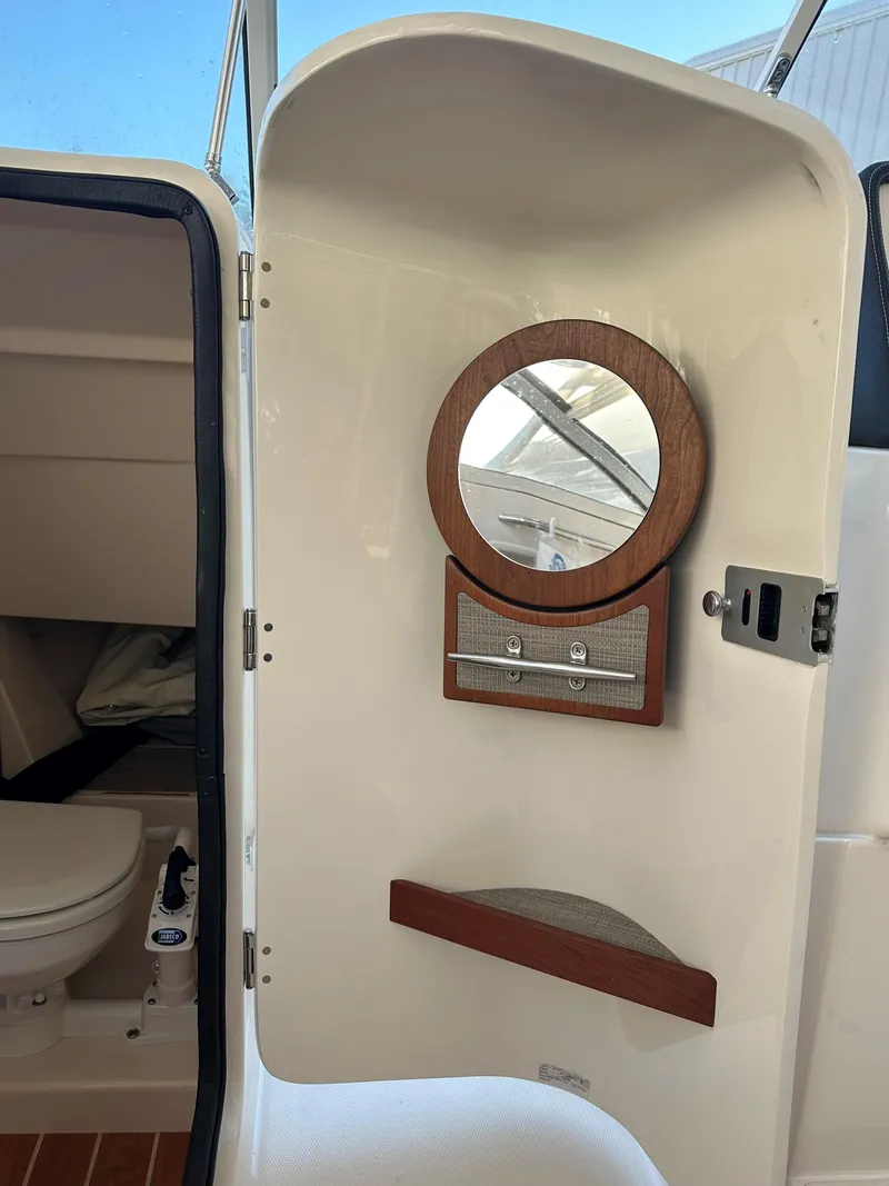 Slide: The Image of 2021 Grady-White Freedom 235 boat interior with mirror and storage. - 16