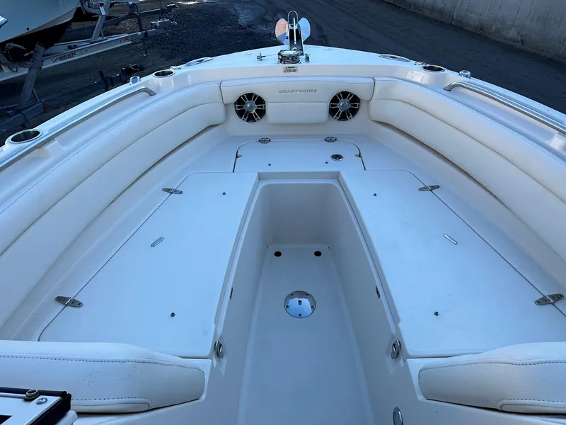 Slide: The Image of 2021 Grady-White Freedom 235 boat interior with white seating and storage compartments. - 6