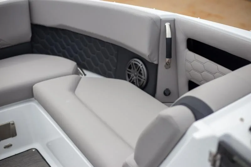 Slide: The Image of 2025 Four Winns H6 boat interior with gray cushioned seating and hexagonal pattern accents. - 11