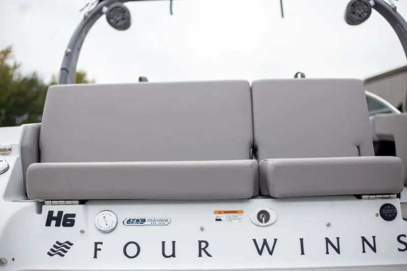 Slide: The Image of 2025 Four Winns H6 boat with gray seating and brand logo. - 12