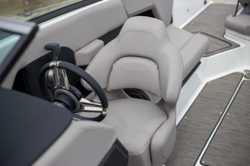 Slide: The Image of 2025 Four Winns H6 boat interior with sleek steering wheel and comfortable seating. - 9