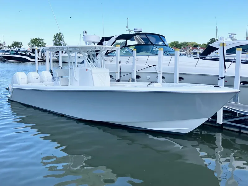 Slide: The Image of 2020 Contender 35 ST boat docked in marina, featuring sleek design and triple engines. - 1