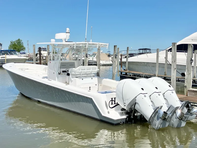 Slide: The Image of 2020 Contender 35 ST boat with dual outboard engines docked in marina. - 2