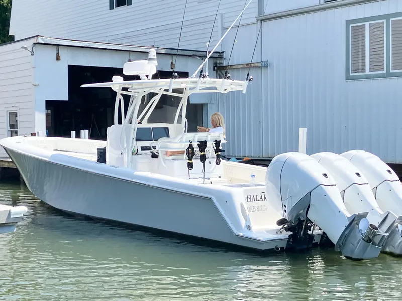 Slide: The Image of 2020 Contender 35 ST boat docked with triple outboard engines. - 5