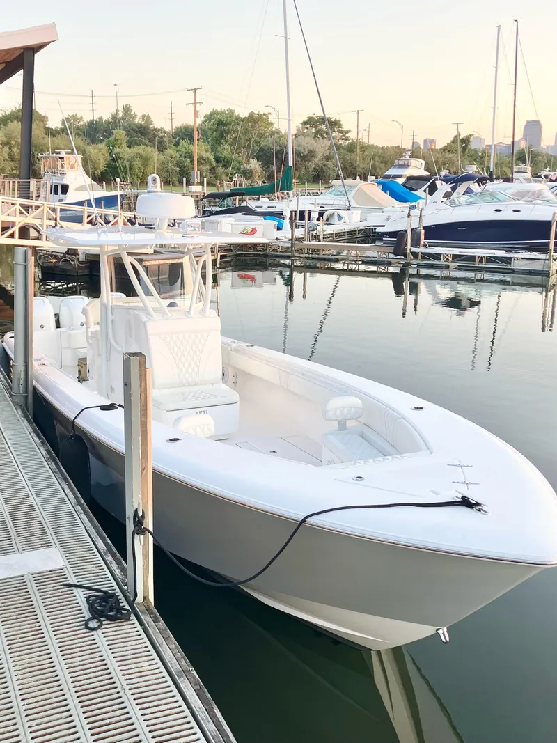 Slide: The Image of 2020 Contender 35 ST boat docked in a marina with other vessels. - 6