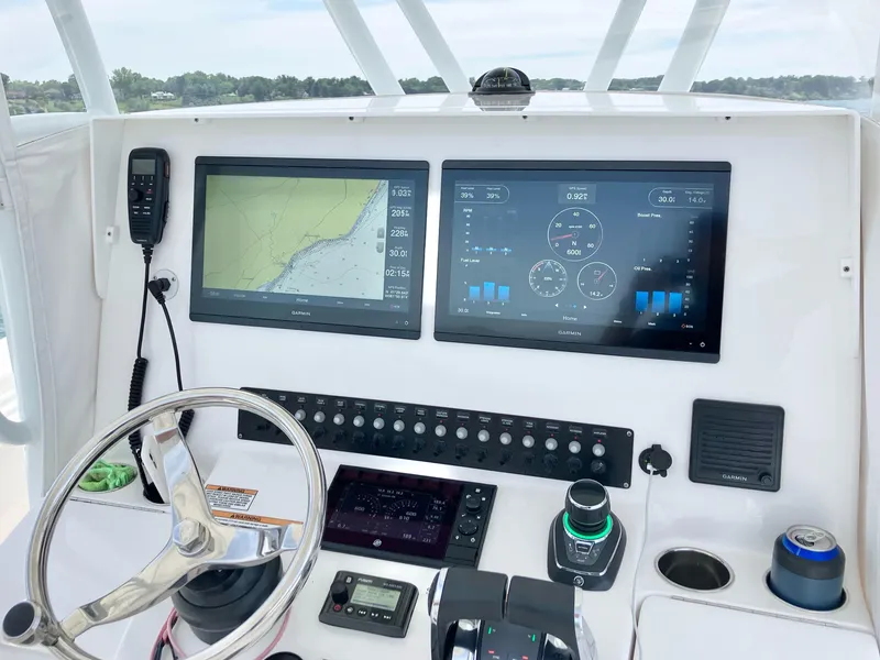 Slide: The Image of Contender 35 ST 2020 boat dashboard with navigation screens and controls. - 7