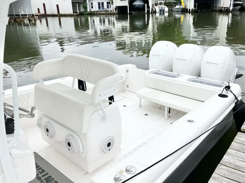 Slide: The Image of 2020 Contender 35 ST boat with triple engines docked by waterfront homes. - 8