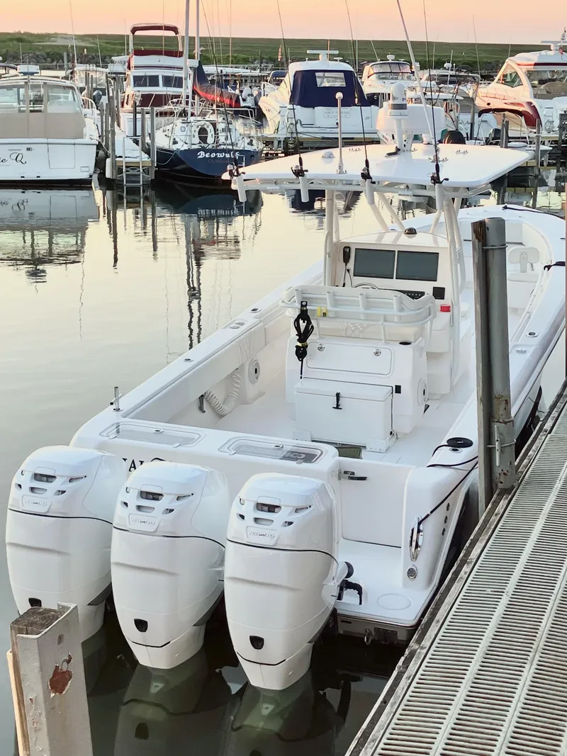Slide: The Image of 2020 Contender 35 ST boat docked with triple outboard engines. - 9