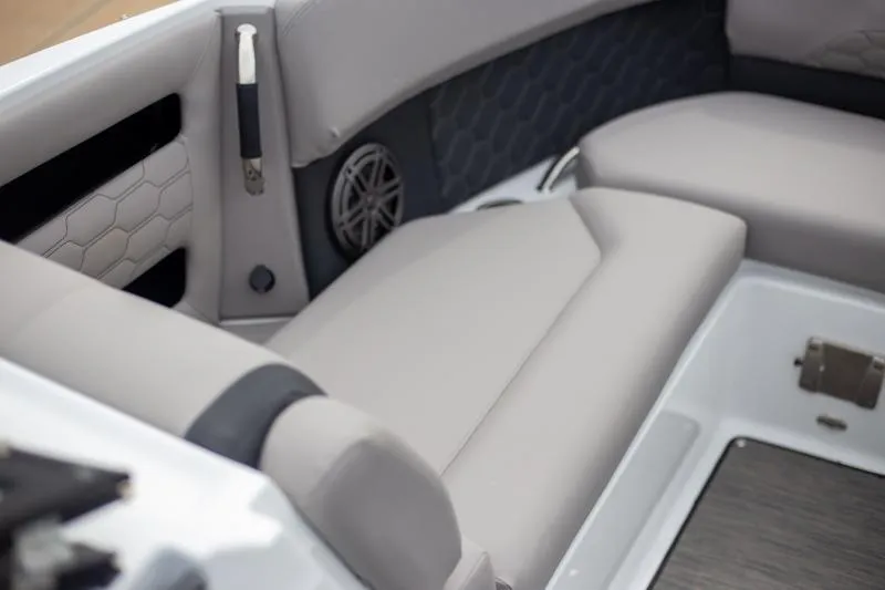 Slide: The Image of 2025 Four Winns H6 boat interior with gray seating and speaker detail. - 10
