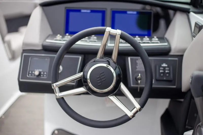 Slide: The Image of Steering wheel and dashboard of 2025 Four Winns H6 boat. - 15