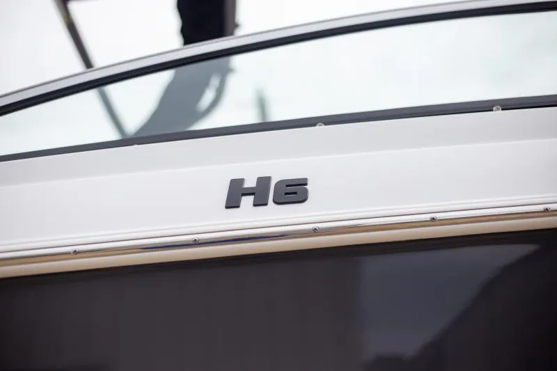 Slide: The Image of 2025 Four Winns H6 boat exterior with model name displayed. - 5