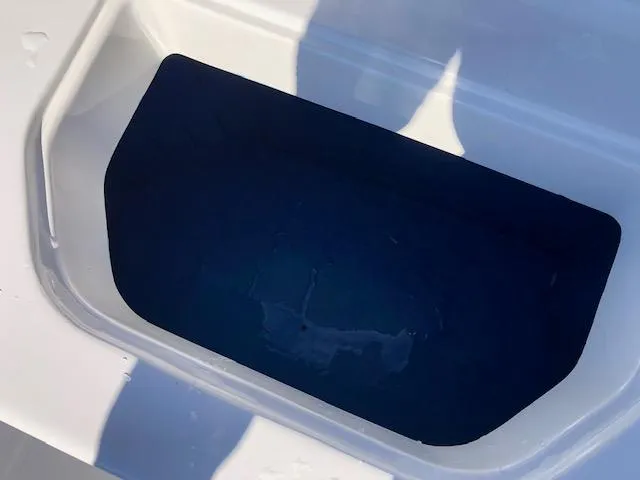 Slide: The Image of White Reflex Gladiator 2024 boat interior with a dark storage compartment. - 17