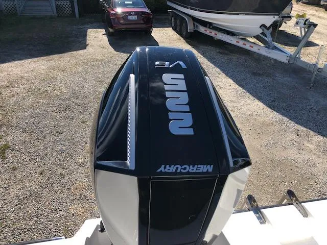 Slide: The Image of Mercury V8 outboard engine on a boat, with a car and trailer in the background. - 19