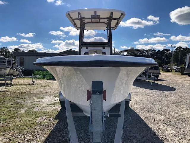 Slide: The Image of 2024 Reflex Gladiator boat on trailer under blue sky. - 2