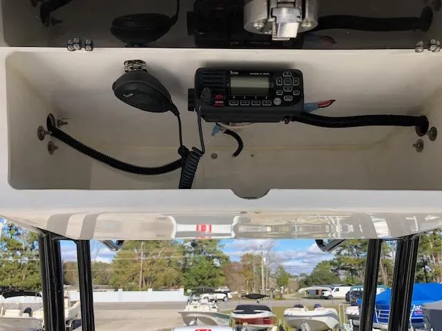 Slide: The Image of 2024 Reflex Gladiator boat radio compartment with microphone and wiring. - 26