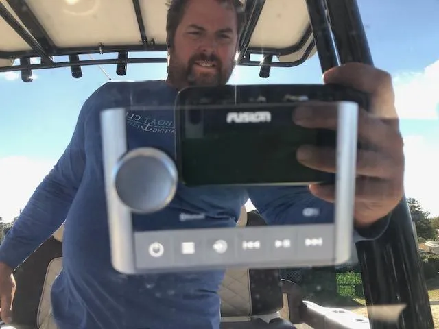 Slide: The Image of Reflection of a man in a 2024 Reflex Gladiator boat console. - 32