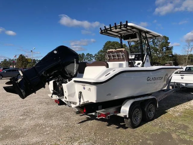 Slide: The Image of 2024 Reflex Gladiator boat on trailer, parked outdoors under blue sky. - 5