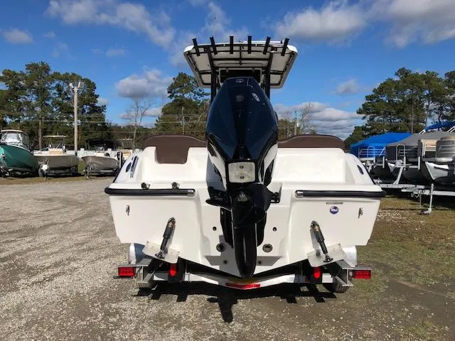 Slide: The Image of 2024 Reflex Gladiator boat with outboard motor on trailer, parked outdoors. - 6