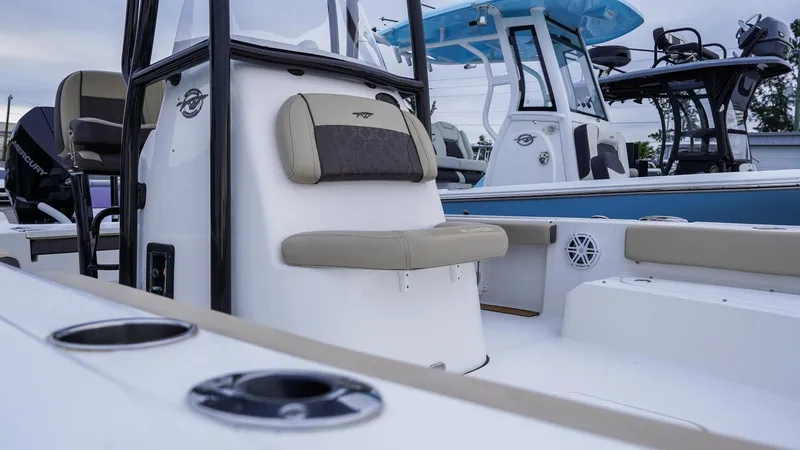 Slide: The Image of 2022 Tidewater 2300 Carolina Bay boat interior with seating and console details. - 10
