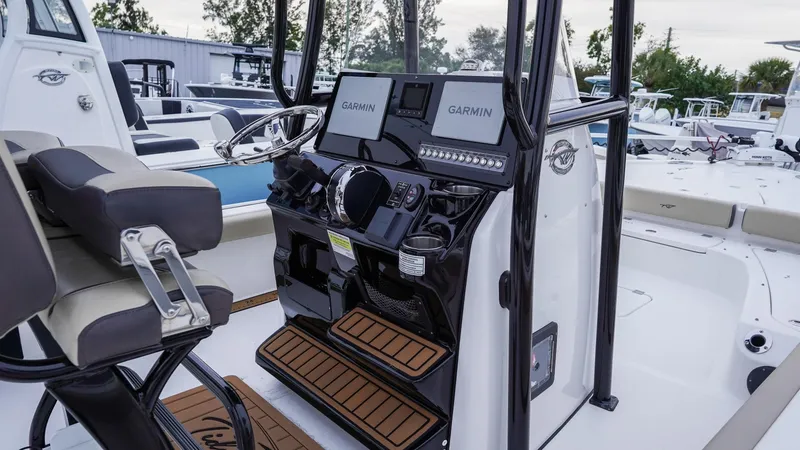 Slide: The Image of 2022 Tidewater 2300 Carolina Bay boat console with Garmin displays and seating. - 7