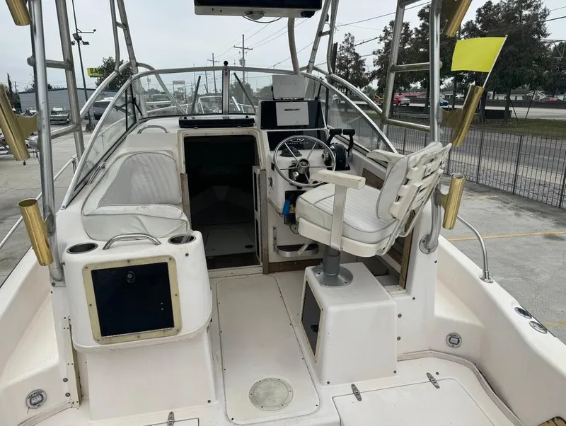 Slide: The Image of 1995 Grady-White 268 Islander WA boat interior with helm and seating area. - 10
