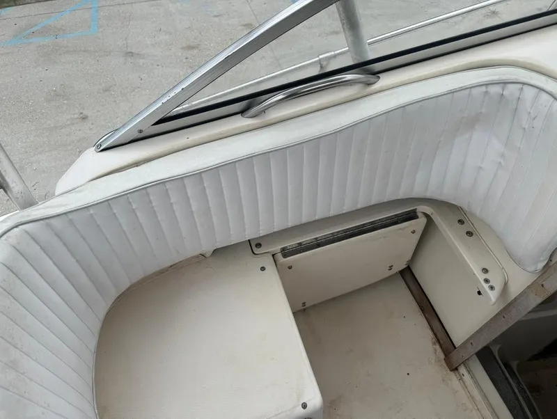 Slide: The Image of Interior seating of 1995 Grady-White 268 Islander WA boat, featuring white upholstery. - 12