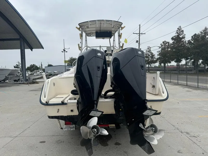 Slide: The Image of 1995 Grady-White 268 Islander WA boat with dual outboard motors, parked outdoors. - 6
