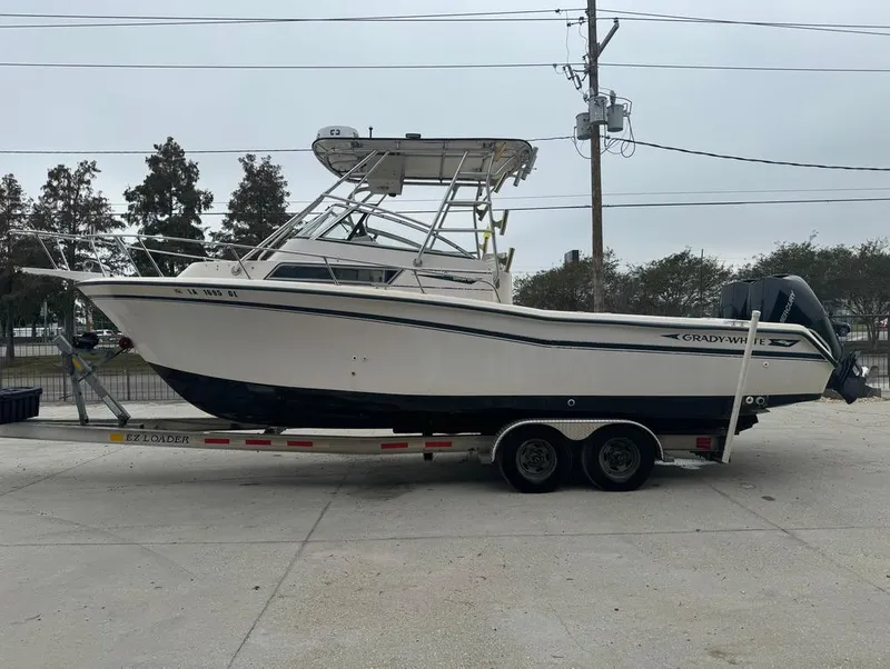 Slide: The Image of 1995 Grady-White 268 Islander WA boat on trailer, parked outdoors. - 8