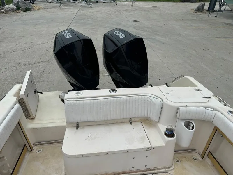 Slide: The Image of 1995 Grady-White 268 Islander WA boat with twin outboard engines, docked on concrete. - 9