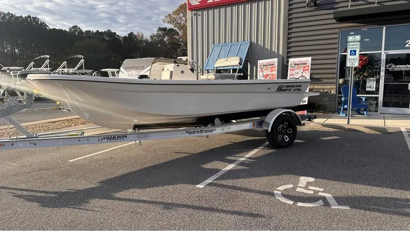 Slide: The Image of 2025 Carolina Skiff 178 JLS CC boat on trailer outside dealership. - 2