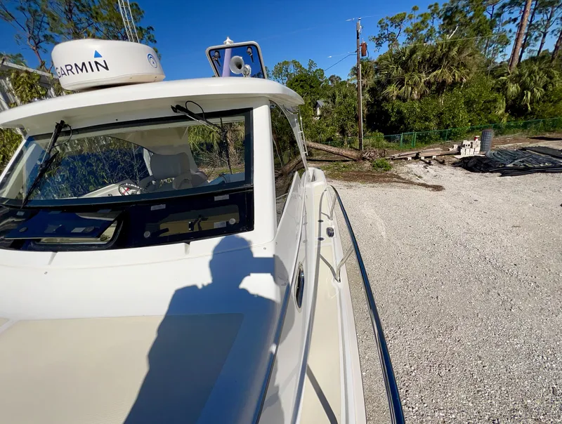 Slide: The Image of Marlow Pilot 31 boat, 2016 model, parked on gravel with trees in the background. - 11