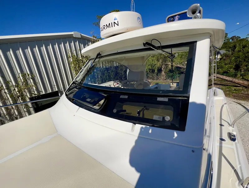 Slide: The Image of 2016 Marlow Pilot 31 boat with Garmin radar, docked under clear blue sky. - 12
