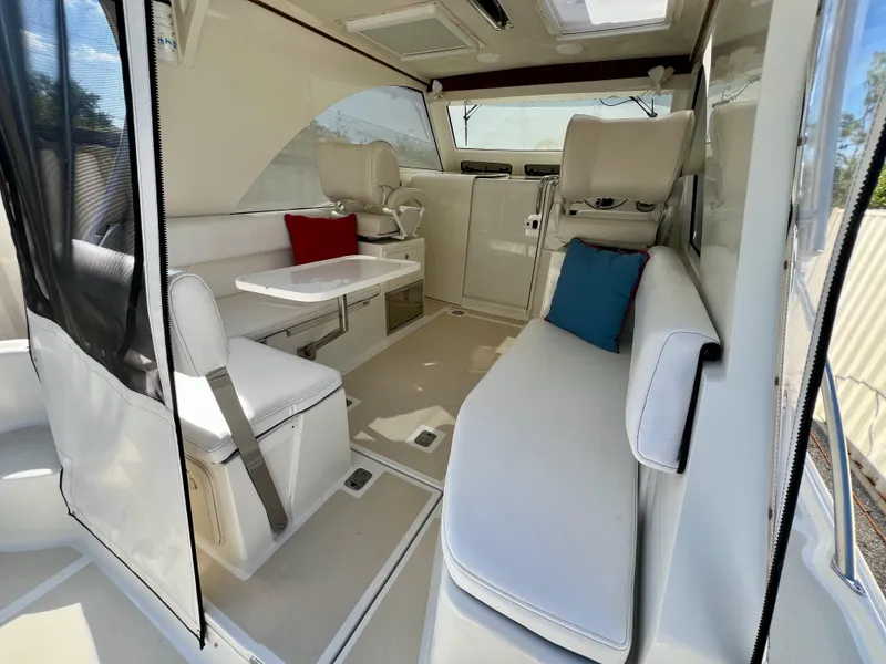 Slide: The Image of Interior of 2016 Marlow Pilot 31, featuring white seating and colorful cushions. - 19