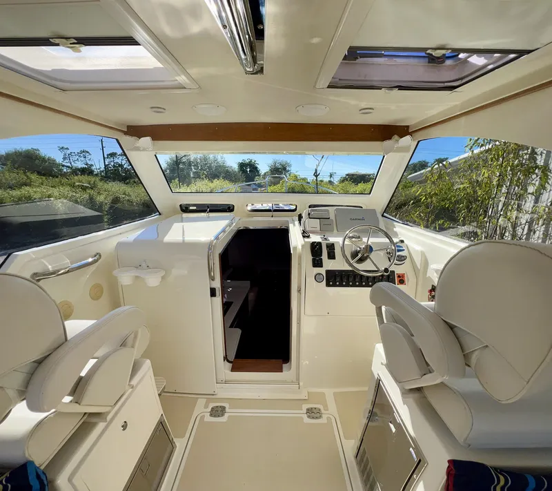 Slide: The Image of Interior of 2016 Marlow Pilot 31, featuring helm and seating area. - 22