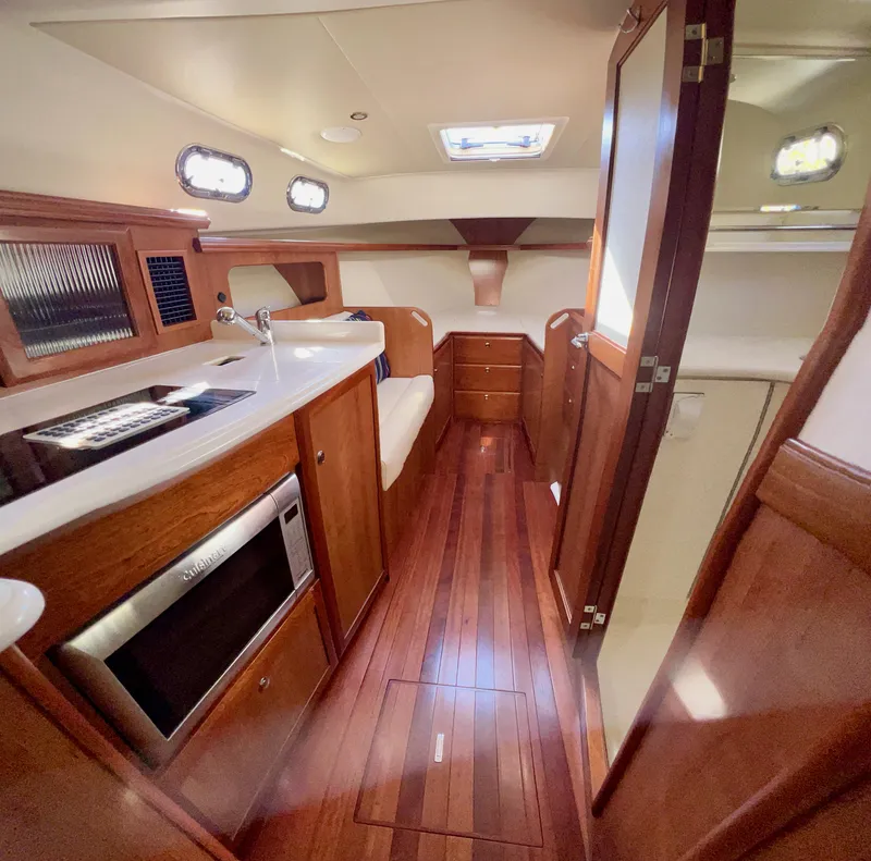 Slide: The Image of Interior of 2016 Marlow Pilot 31 yacht with wood finish and modern amenities. - 34