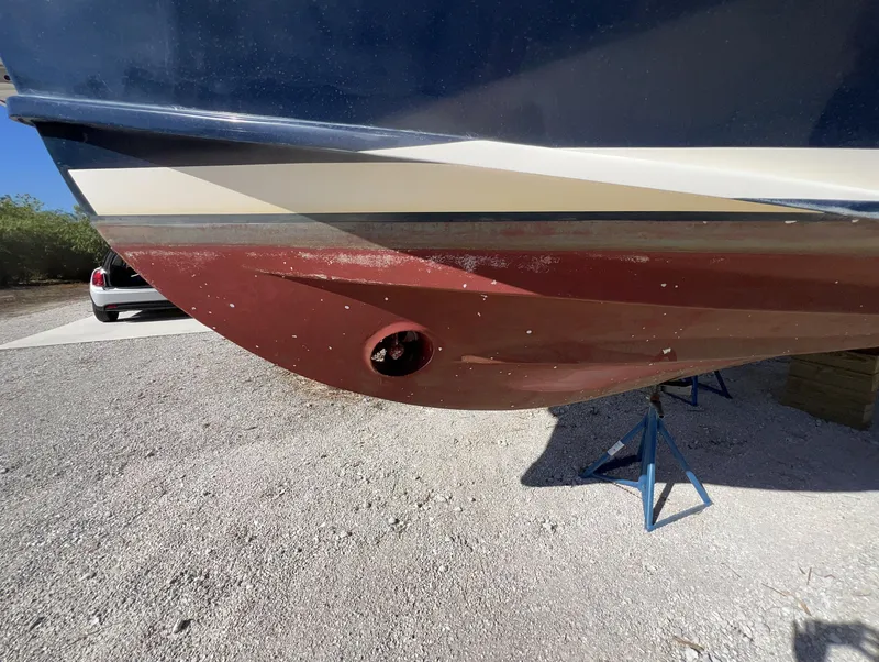 Slide: The Image of Marlow Pilot 31 boat hull, 2016 model, on stands in a gravel area. - 4