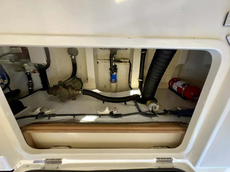 Slide: The Image of Engine compartment of 2016 Marlow Pilot 31 with visible hoses and fire extinguisher. - 45