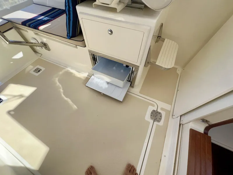 Slide: The Image of Interior of 2016 Marlow Pilot 31 with storage compartment and seating area. - 49