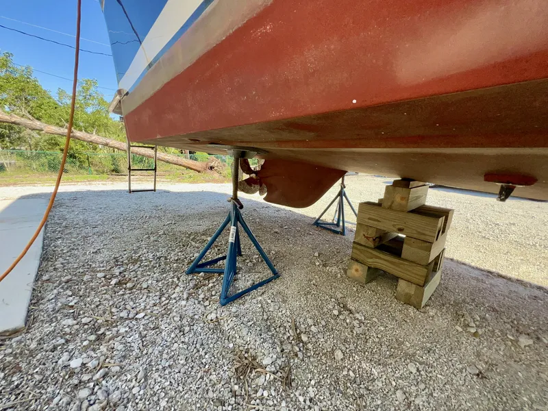Slide: The Image of 2016 Marlow Pilot 31 boat hull on stands, gravel ground. - 5