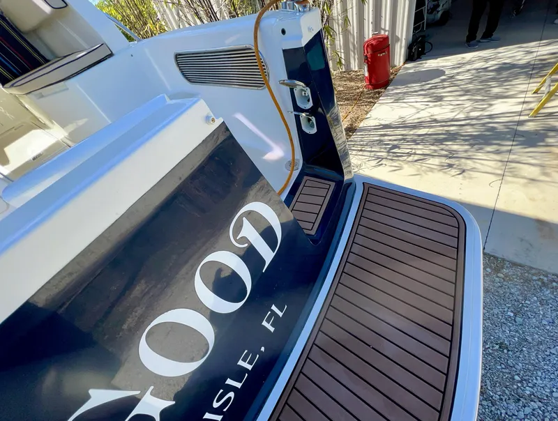 Slide: The Image of Marlow Pilot 31 boat stern, 2016 model, docked with wooden deck. - 8